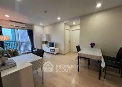 Modern living room with dining area and balcony view in a stylish apartment.