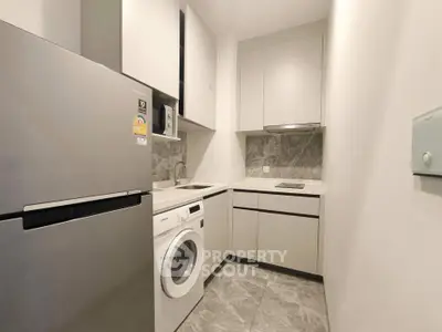 Modern compact kitchen with sleek appliances and stylish cabinetry