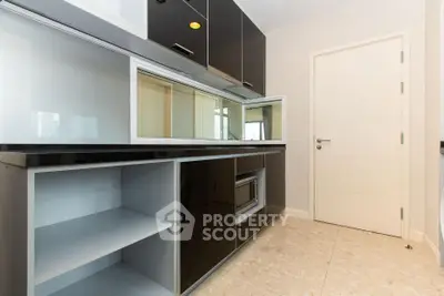 Modern kitchen with sleek black cabinets and built-in microwave