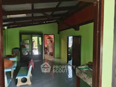 Charming rustic interior with vibrant green walls and open layout, perfect for cozy living.