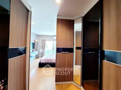 Spacious bedroom with modern wooden wardrobes and natural light
