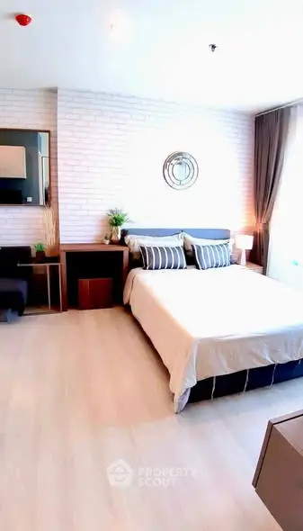 Spacious modern bedroom with stylish decor and natural light