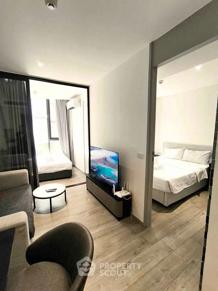 Modern apartment interior with cozy living room and bedroom, featuring stylish furniture and natural light.
