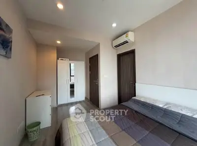 Modern bedroom with air conditioning and stylish decor in a contemporary apartment.