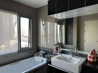 Modern bathroom with city view, featuring sleek black and white design and a spacious bathtub.