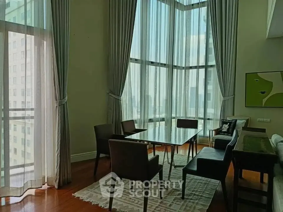 Spacious living room with floor-to-ceiling windows and elegant decor