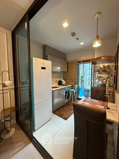 Modern kitchen with open layout and stylish dining area in a contemporary apartment.