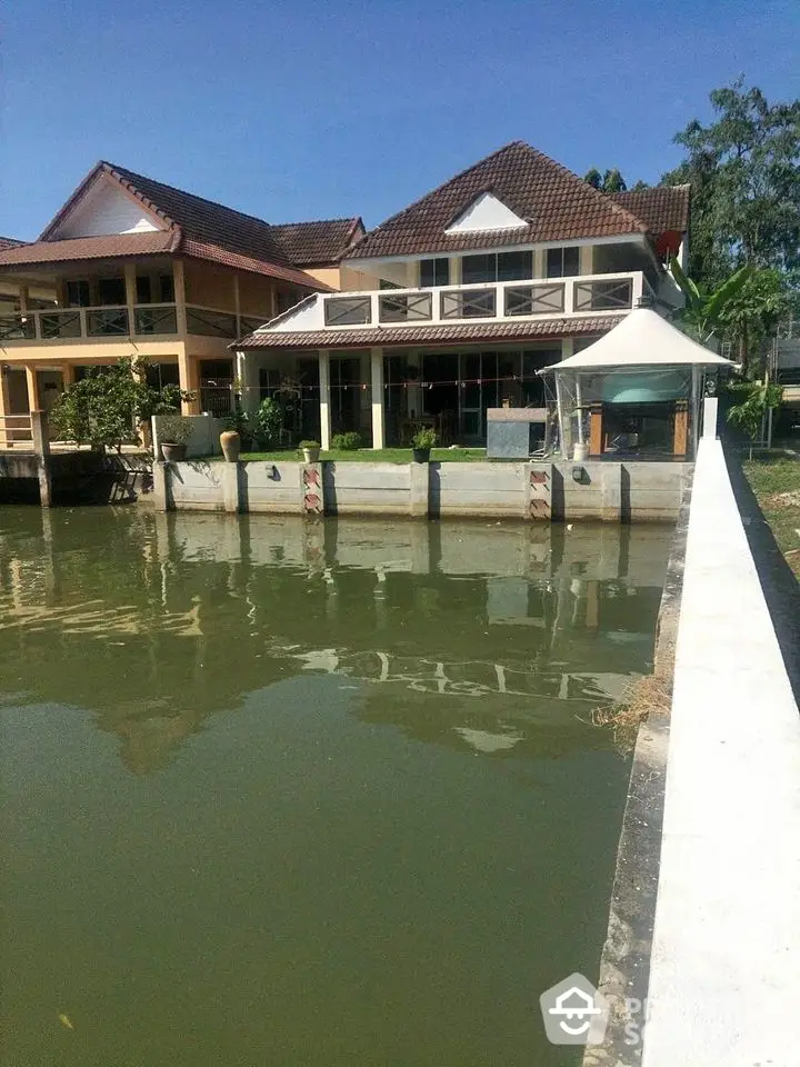 Charming waterfront property with traditional architecture and serene canal view.