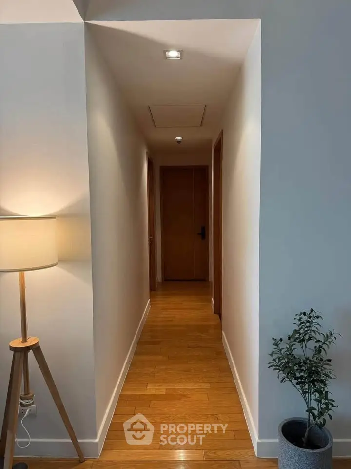 Elegant hallway with wooden flooring and modern decor in a stylish apartment.