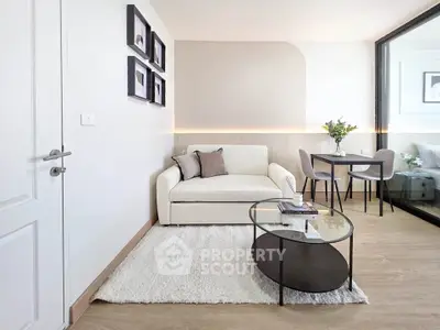 Modern living room with cozy sofa, stylish decor, and elegant dining area in a bright apartment.