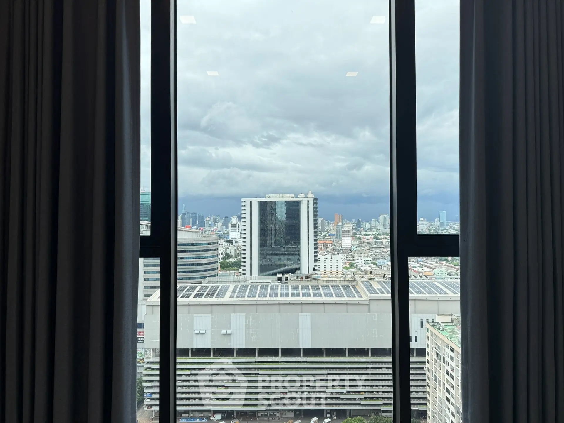 Stunning cityscape view from a high-rise window, showcasing urban skyline and modern architecture.