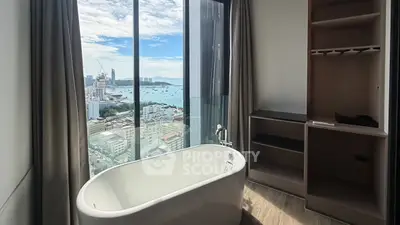 Luxurious bathroom with stunning city and ocean view from high-rise apartment