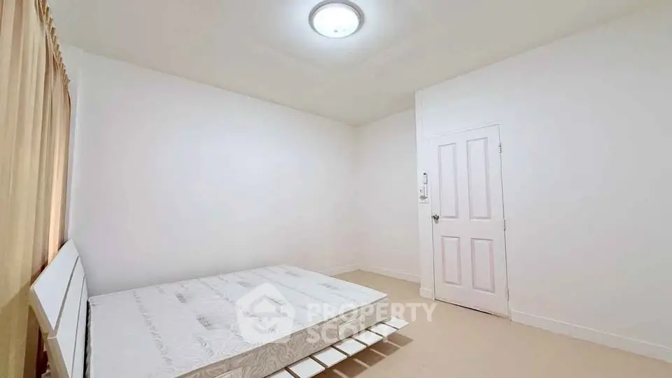 Spacious minimalist bedroom with natural light and modern design