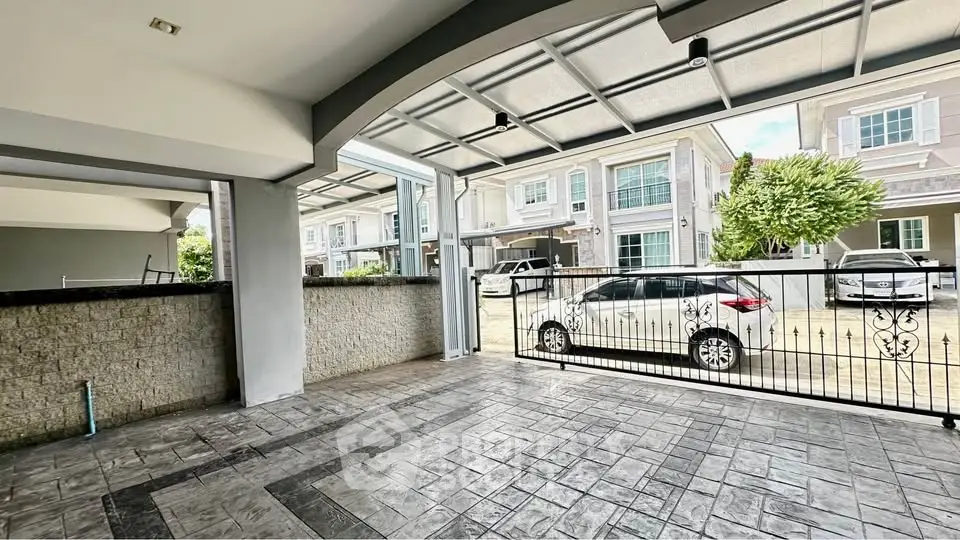 Spacious covered parking area with modern design in a residential neighborhood.