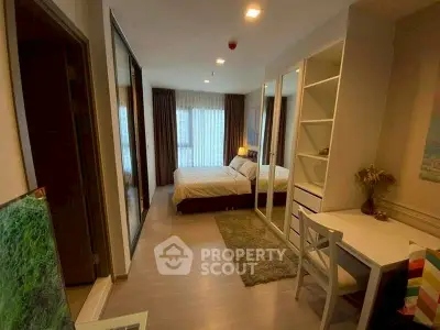 Modern bedroom with stylish decor and workspace, featuring large windows and cozy ambiance.