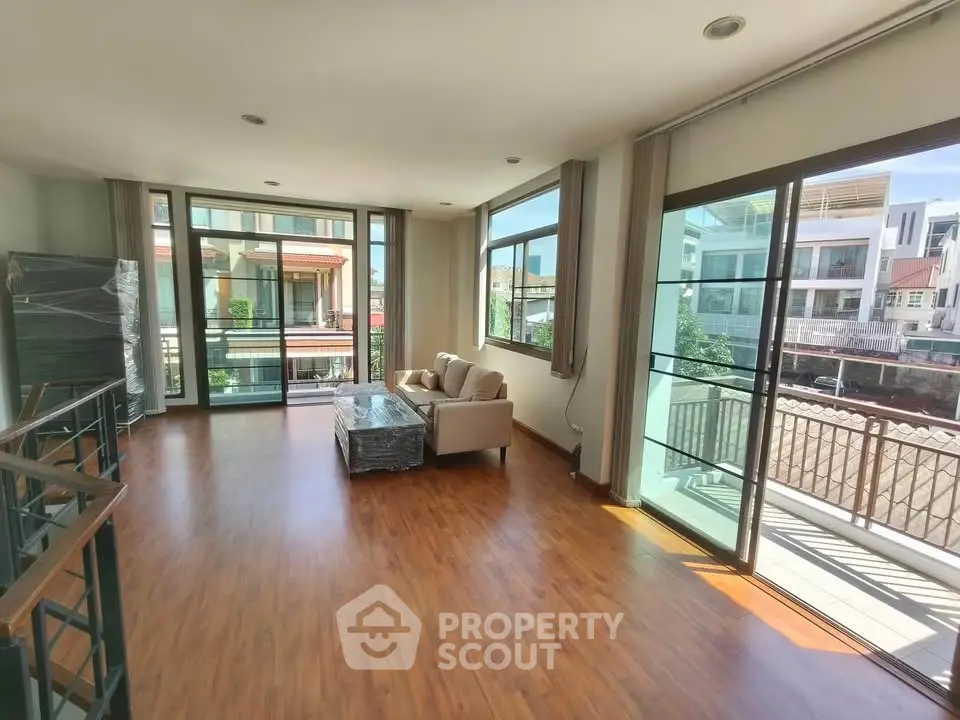 Spacious living room with large windows and balcony in modern apartment