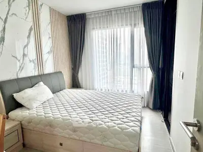 Modern bedroom with stylish decor and large window for natural light