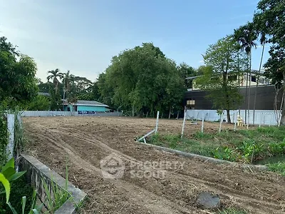 Spacious vacant land plot surrounded by lush greenery, ideal for development opportunities.