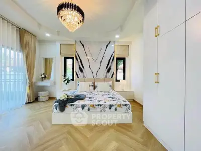 Luxurious bedroom with elegant chandelier and modern decor