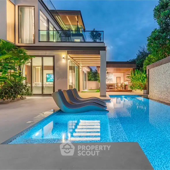 Luxurious modern villa with stunning pool and elegant outdoor seating area at dusk.