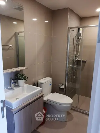 Modern bathroom with sleek fixtures and glass shower enclosure