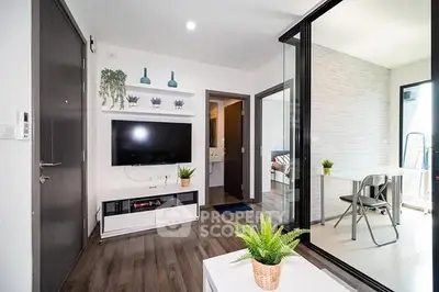 Modern living room with sleek decor and adjacent study area, featuring bright natural light and stylish furnishings.