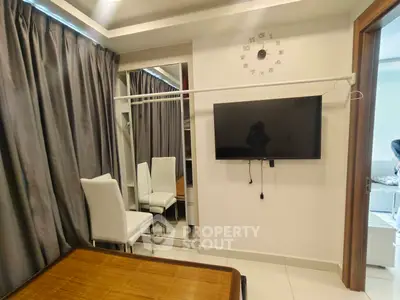 Modern living room with wall-mounted TV and elegant white chairs