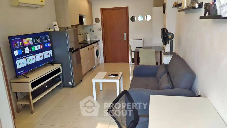 Modern living room with sleek furniture and integrated kitchen appliances