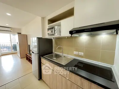 Modern kitchen with sleek appliances and open layout in a stylish apartment