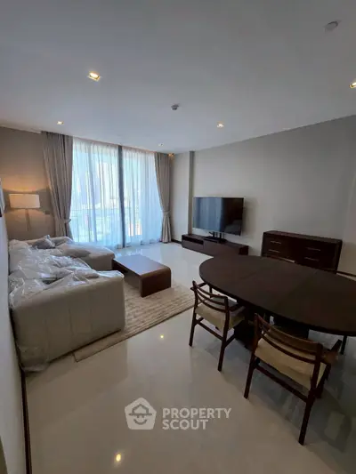 Spacious modern living room with large windows and elegant furniture