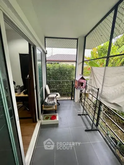 Charming balcony with garden view, perfect for relaxation and outdoor enjoyment.