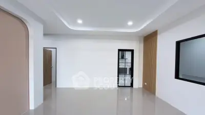 Spacious modern living room with sleek design and ample natural light.