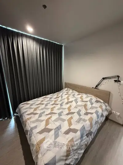 Cozy bedroom with modern decor and stylish bedding in a contemporary apartment.