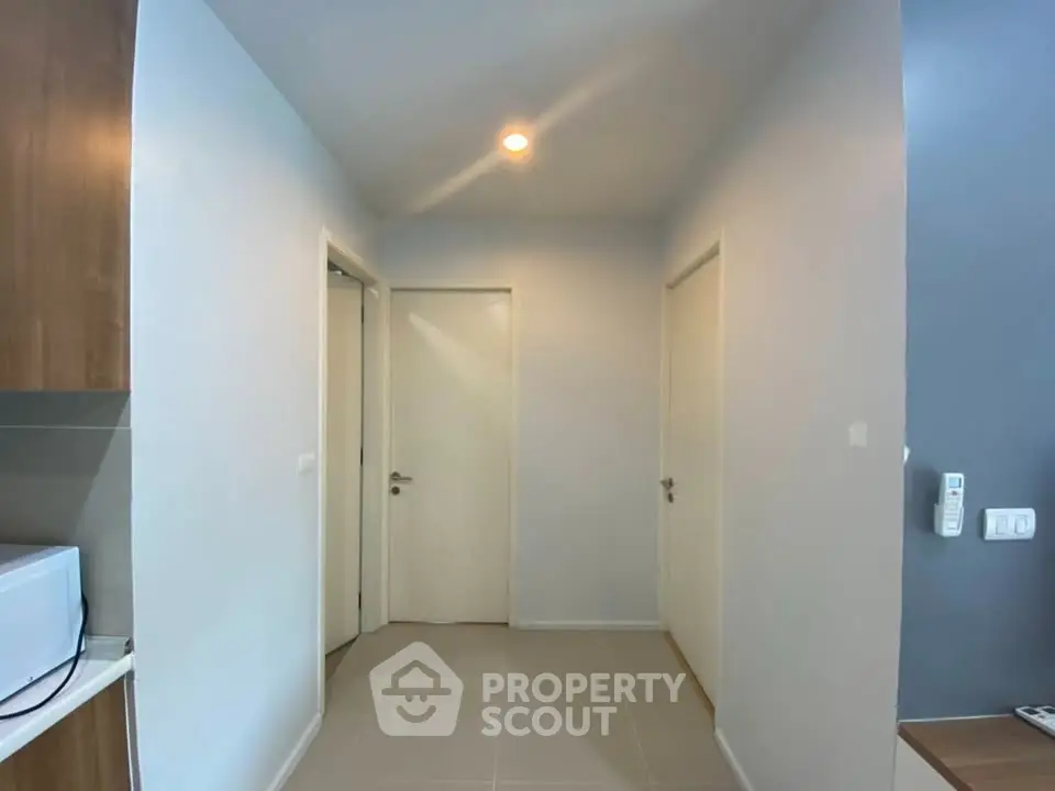 Modern hallway with white doors and sleek lighting in a contemporary home.