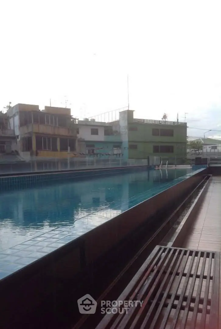 Charming urban rooftop pool with cityscape views, ideal for relaxation and leisure.