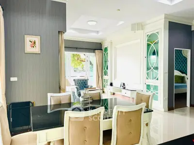 Elegant dining and living area with modern decor and natural light