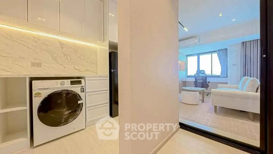 Modern apartment interior with washing machine and cozy living area