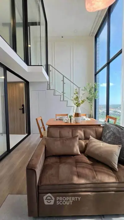 Luxurious modern living room with high ceilings and stunning city view, featuring elegant furniture and stylish decor.