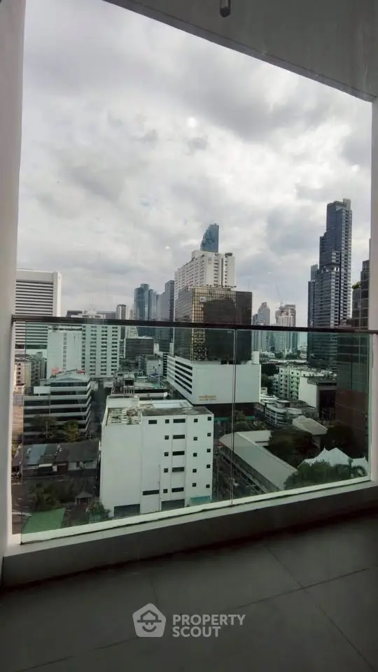 Stunning cityscape view from a high-rise balcony, showcasing modern urban architecture.