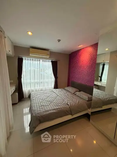 Modern bedroom with stylish decor and large window for natural light