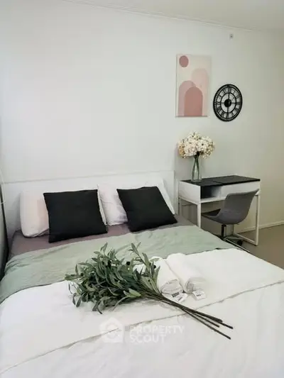 Cozy bedroom with modern decor and study desk, perfect for relaxation and productivity.