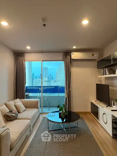 Modern living room with city view, featuring cozy sofa, sleek TV unit, and balcony access.