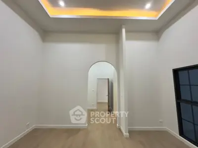 Spacious modern interior with high ceilings and elegant archway