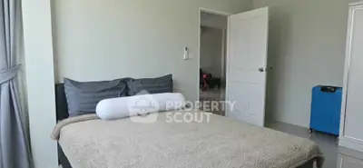 Cozy bedroom with neutral tones and modern decor, perfect for relaxation.