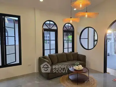 Stylish living room with modern sofa and unique window design