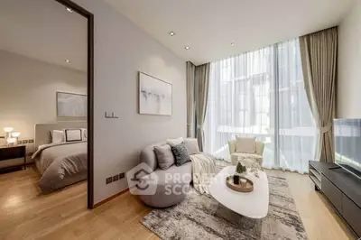 Modern living room with elegant decor and natural light, adjacent to a cozy bedroom.