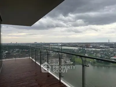 Stunning high-rise balcony with panoramic river and city views, perfect for relaxation and entertainment.