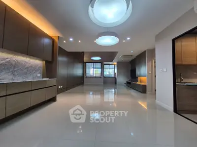 Spacious modern living room with sleek cabinetry and elegant lighting