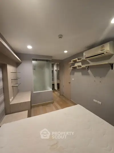 Modern bedroom with air conditioning and stylish shelving