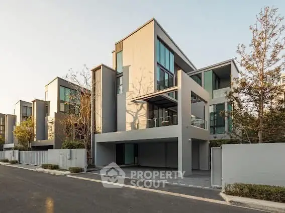 Modern multi-story residential building with sleek design and large windows